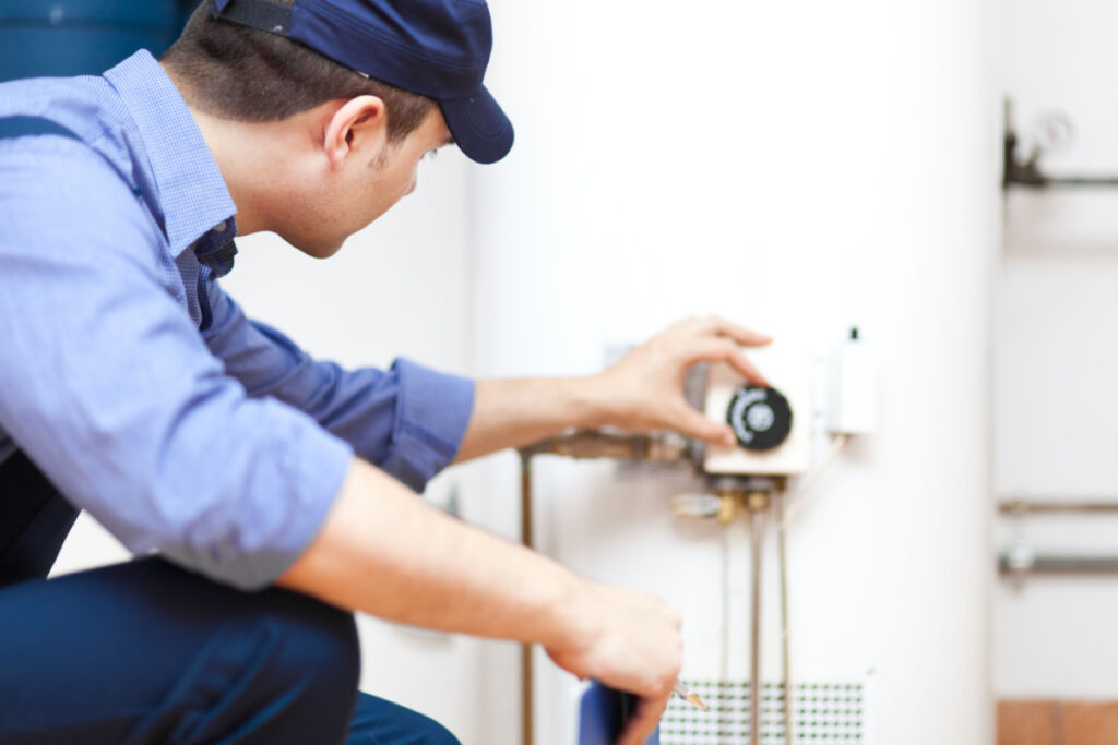Professional adjusting the temperature on a new water heater