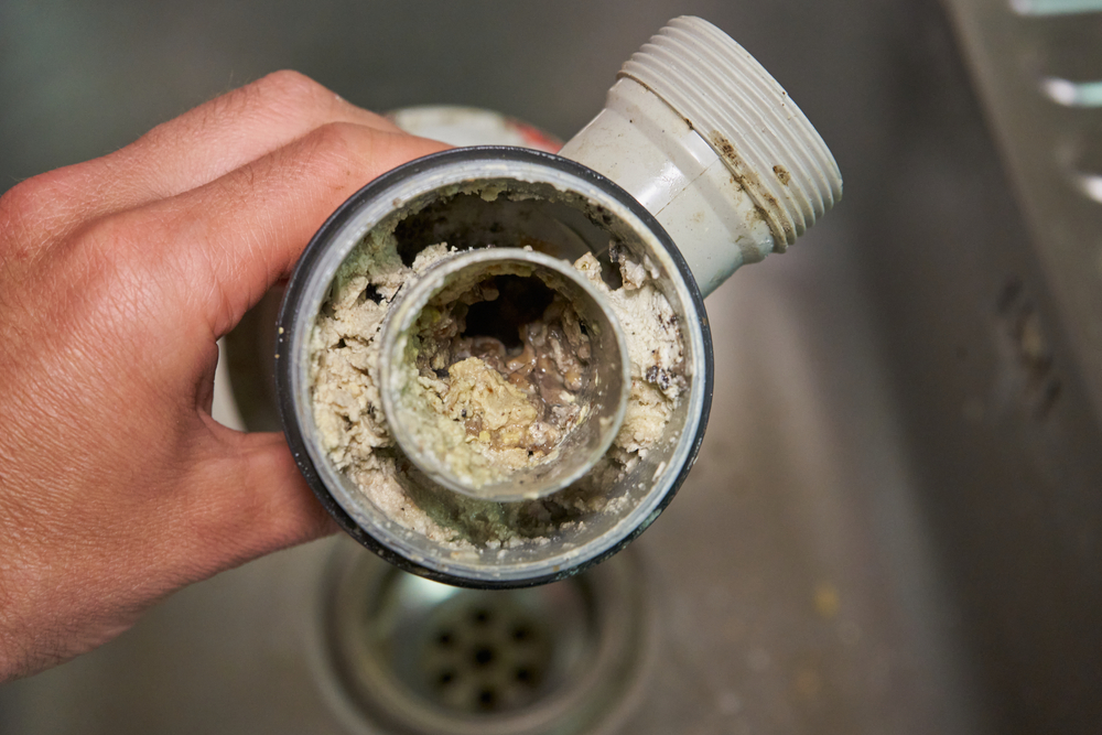 a clogged drain pipe from the kitchen sink that needs drain snaking or hydro jetting